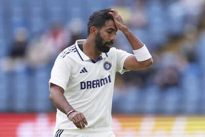 Jasprit Bumrah contemplating his workload during a match.