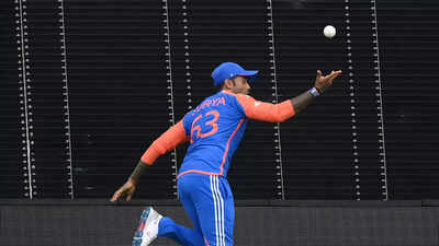 Cricketers celebrating a successful catch