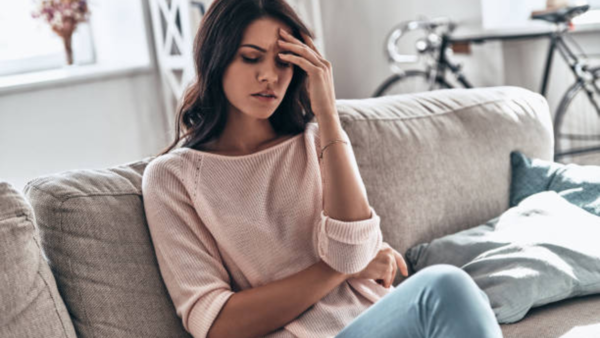 Exhausted woman resting her head on a table