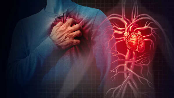 Close-up of a hand holding a chest, indicating heart problems
